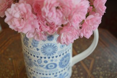 High angle view of pink flower vase on table