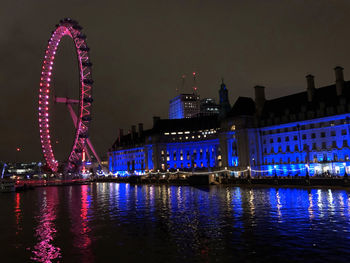 Illuminated ferris wheel at night