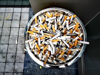 High angle view of cigarette smoking on floor