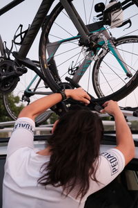 Rear view portrait of woman with bicycle