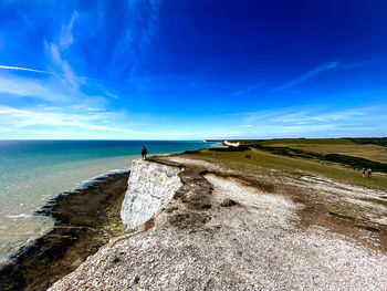 Scenic view of beach against blue sky