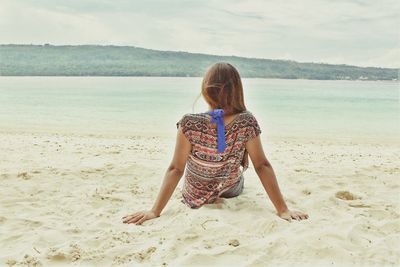 Rear view of girl on beach
