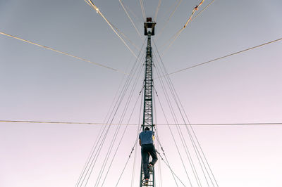 Low angle view of cranes against clear sky