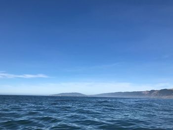 Scenic view of sea against blue sky