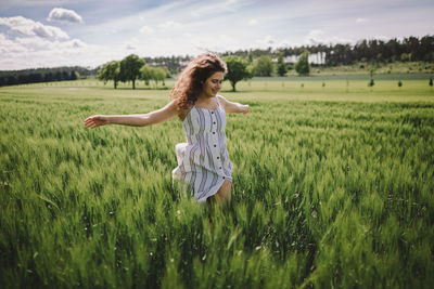 Full length of young woman in farm