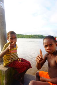 Portrait of boy sitting outdoors