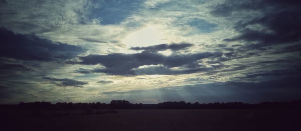 Scenic view of silhouette landscape against sky at sunset