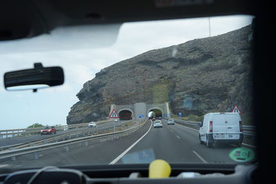 Cars on road seen through windshield