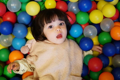 Portrait of cute baby girl in ball pool