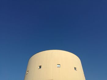 Low angle view of building against clear blue sky