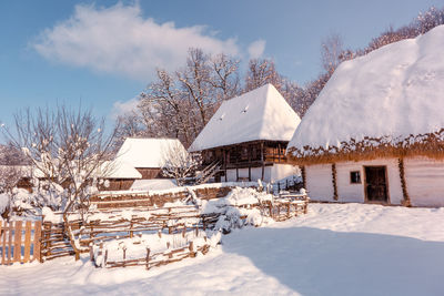 Traditional romanian village in transylvania with old house straw roofing covered with snow