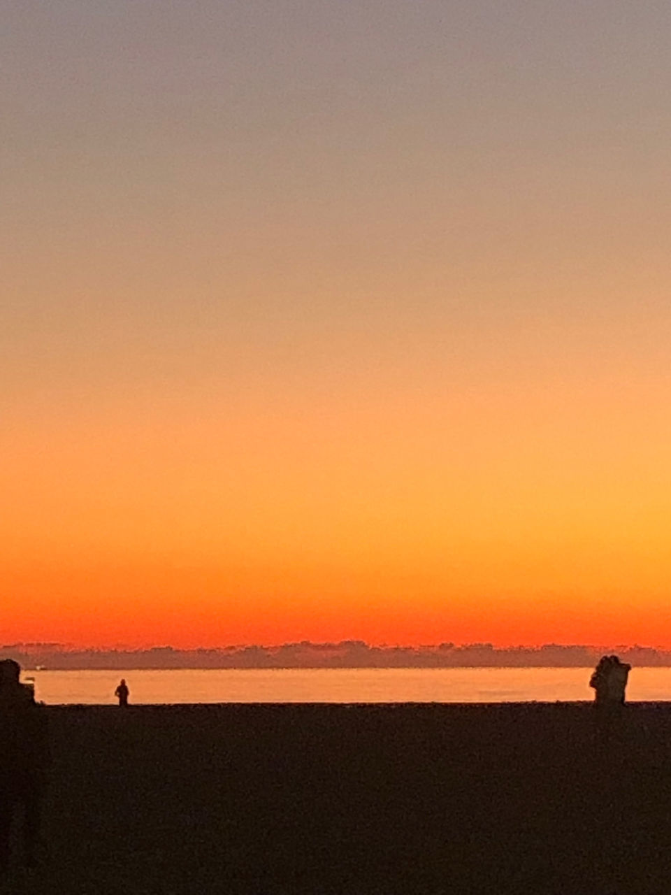 SCENIC VIEW OF BEACH AGAINST CLEAR SKY DURING SUNSET