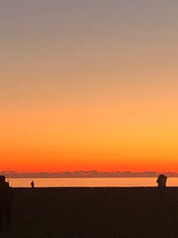 Scenic view of sea against orange sky