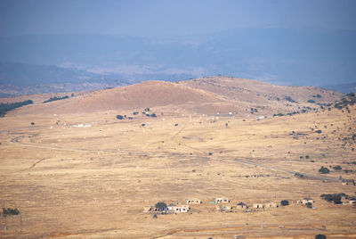 High angle view of hay bales on field against sky