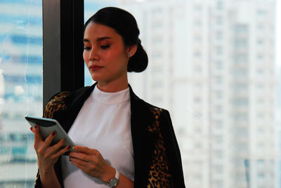 Mid adult woman using mobile phone