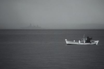 Boat sailing on sea against sky