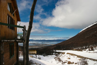 Scenic view of snow covered land against sky