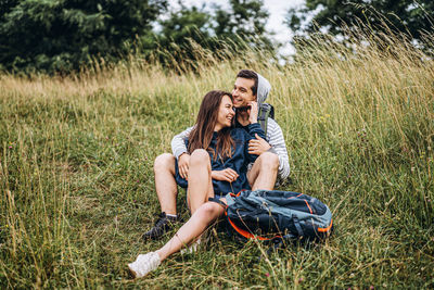 Happy couple sitting in grass