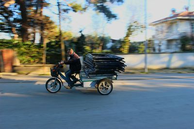 Man riding motorcycle on street in city