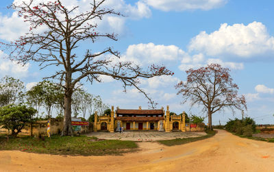 Buildings on field against sky