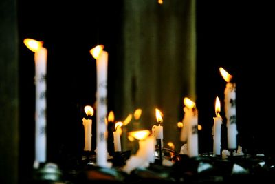 Close-up of lit candles in temple