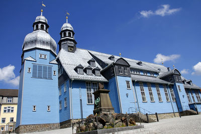 Low angle view of building against blue sky