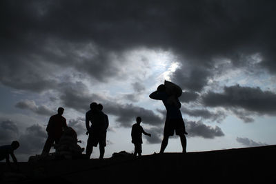 Silhouette children against sky