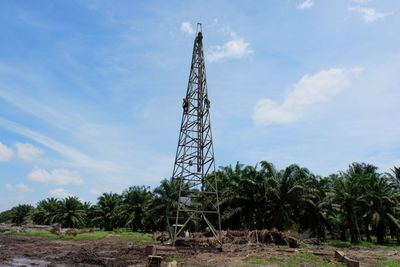 Low angle view of communications tower against sky