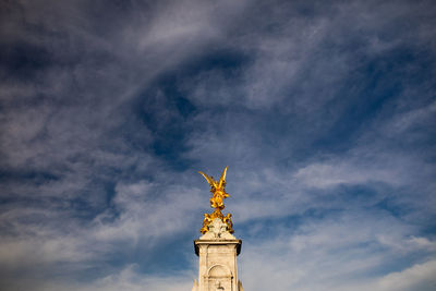 Low angle view of statue against cloudy sky