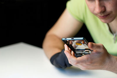 Midsection of man using mobile phone