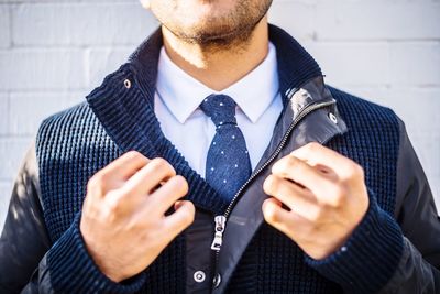 Midsection of man wearing sunglasses in front of woman