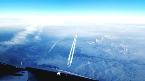 Aerial view of landscape against blue sky