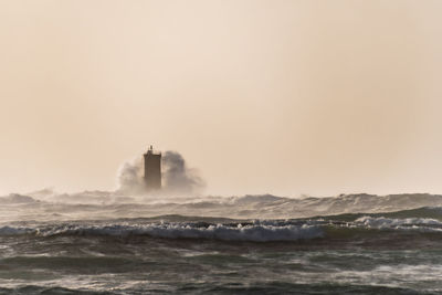 Huge wave storming the lighthouse