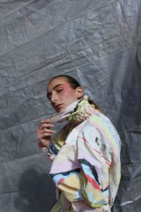 Full length of boy standing against wall