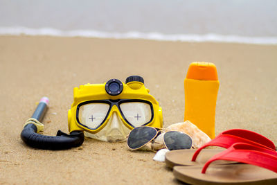 Close-up of yellow shoes on beach