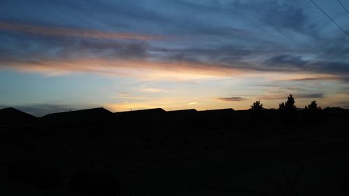 Silhouette landscape against sky during sunset