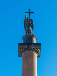 Low angle view of statue against blue sky