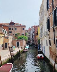 Boats in canal in city