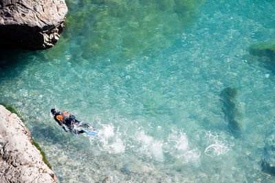 High angle view of people swimming in sea