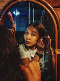 Young woman reflecting on mirror