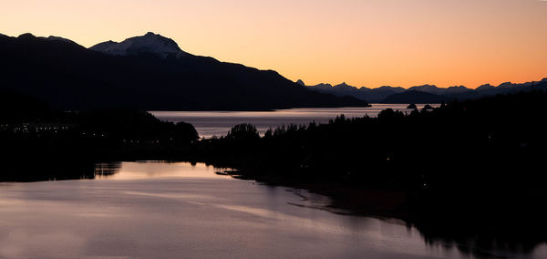 Scenic view of lake against orange sky