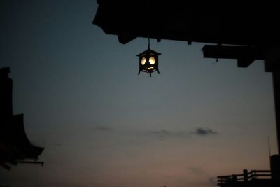 Low angle view of illuminated street light against sky