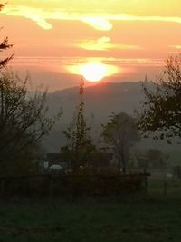 Scenic view of field against sky during sunset