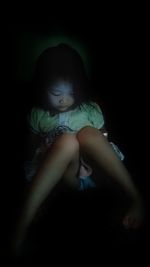 Close-up of woman relaxing on wall