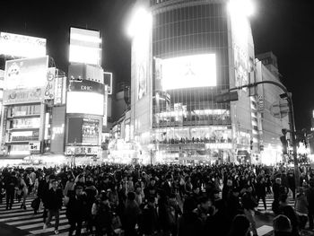 Crowd on illuminated city at night