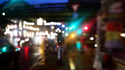 Blurred motion of woman in city at night