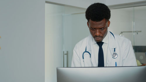 Doctor using digital tablet in office