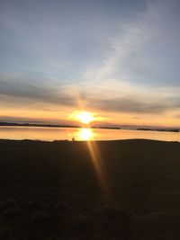 Scenic view of beach against sky during sunset