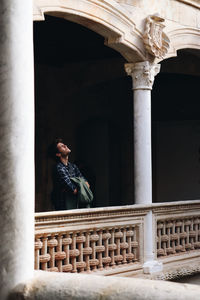 Low angle view of young man looking up 