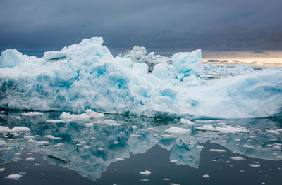 Scenic view of ice berg against sky during winter